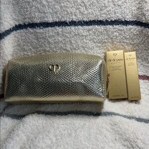 Clé de Peau Beauté Gold Cosmetic bag with travel size skin care, NWT